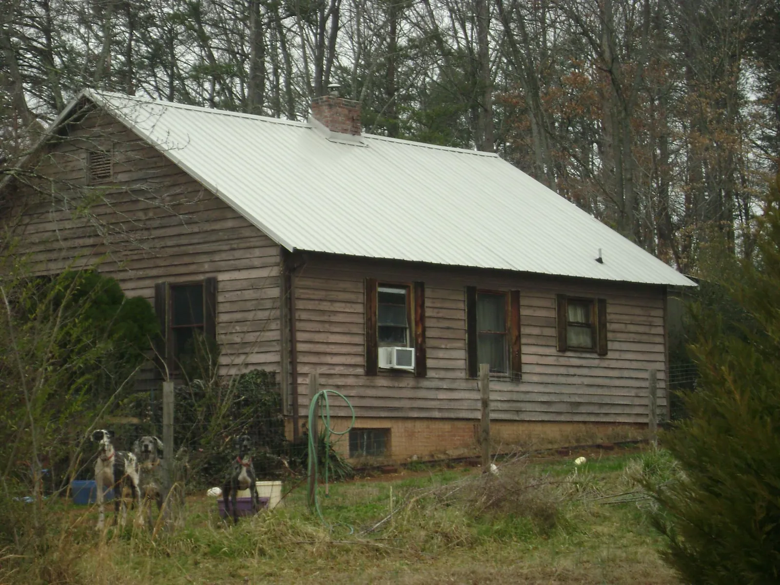 White metal roof on an old wood sided farmhouse, from a Metal Roof Installation job in Quogue